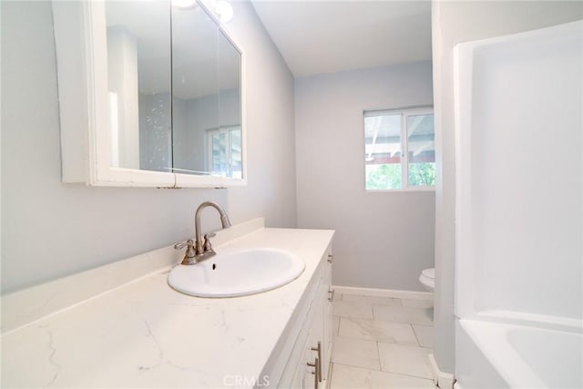 bathroom with vanity, toilet, and a bathtub