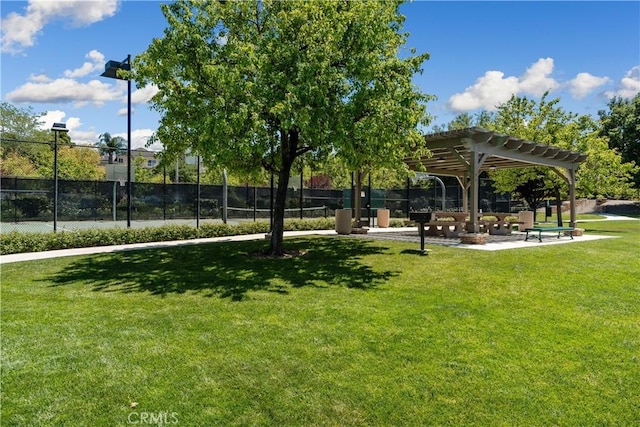 view of community featuring a lawn and a pergola