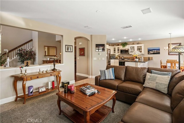 living room featuring an inviting chandelier and tile patterned floors