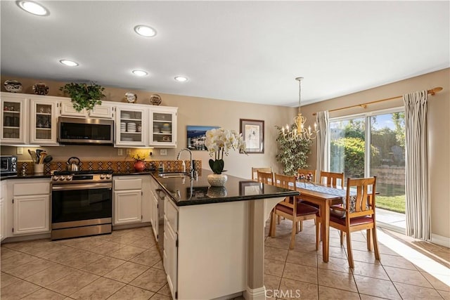 kitchen featuring sink, pendant lighting, white cabinets, and stainless steel appliances