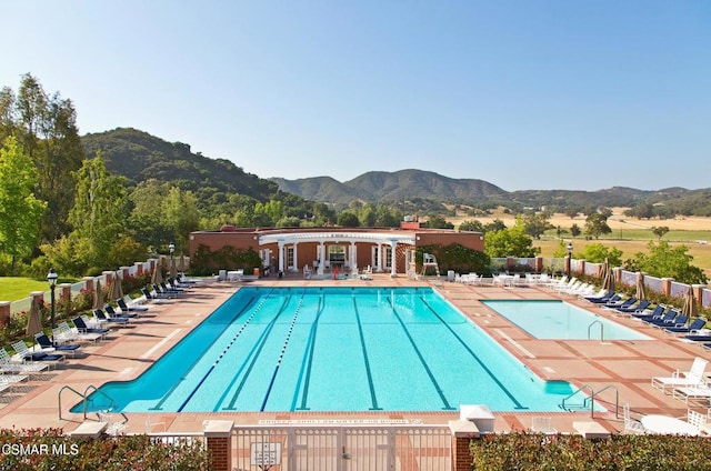 view of pool featuring a mountain view and a patio area