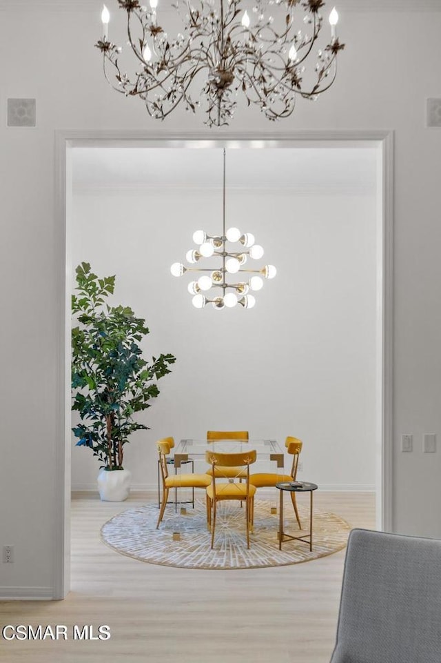 dining room with hardwood / wood-style flooring and an inviting chandelier