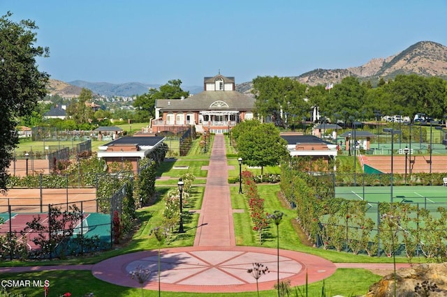 view of community featuring a mountain view and tennis court