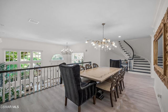 dining area featuring a notable chandelier and light wood-type flooring