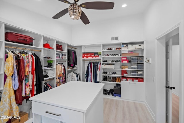 walk in closet featuring ceiling fan and light hardwood / wood-style floors