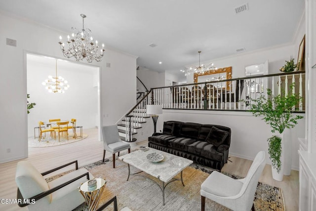 living room featuring a chandelier, light wood-type flooring, and ornamental molding