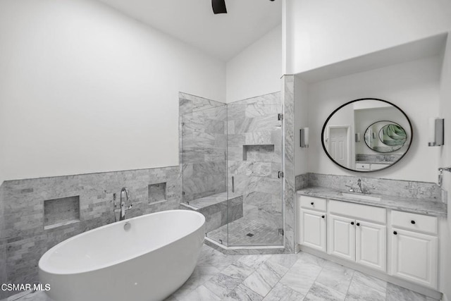 bathroom featuring vanity, ceiling fan, and independent shower and bath