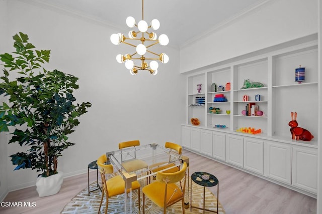 dining space featuring a chandelier, light hardwood / wood-style flooring, and crown molding