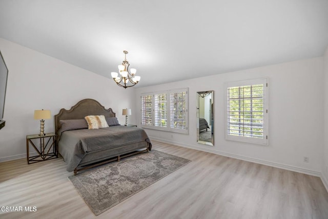 bedroom featuring light wood-type flooring and multiple windows