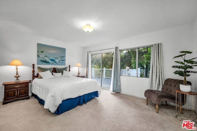 bedroom with access to exterior and light colored carpet