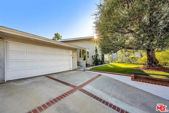 view of front of property with a garage and a front lawn