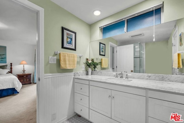 bathroom with vanity and a shower with shower door