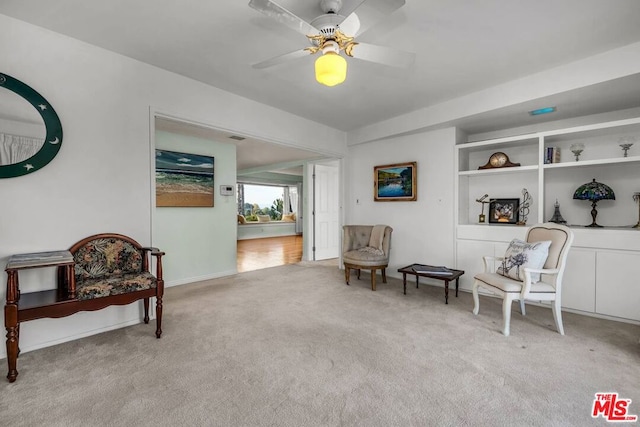 sitting room with light carpet and ceiling fan