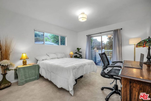 bedroom featuring access to exterior and light carpet