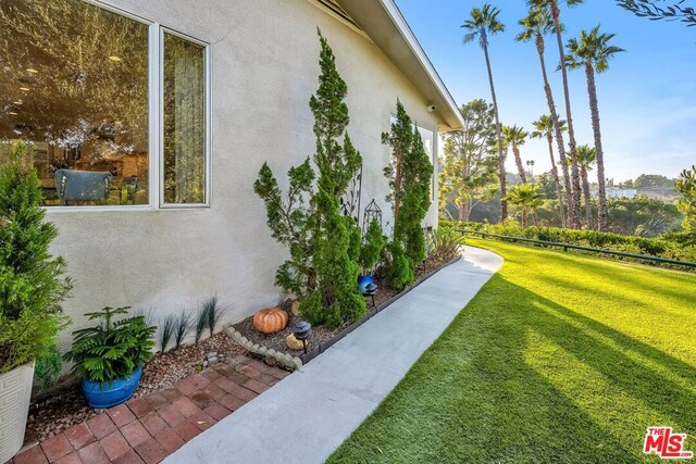 view of side of property with a lawn