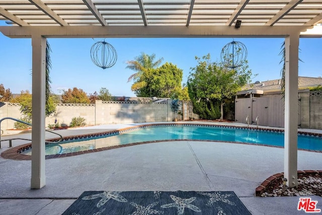 view of swimming pool with a pergola and a patio