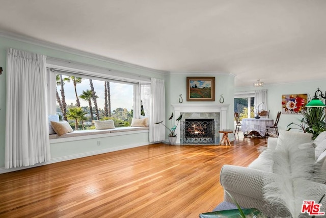 living room featuring wood-type flooring and crown molding