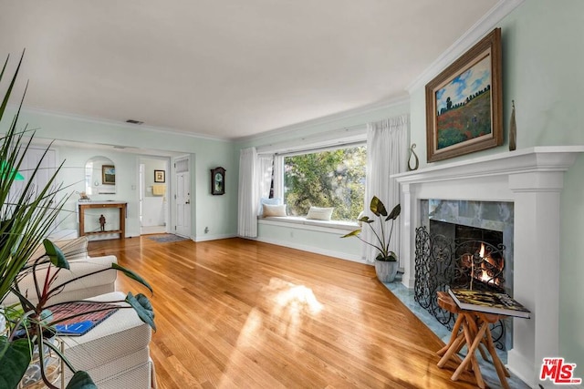 living room with hardwood / wood-style flooring and ornamental molding