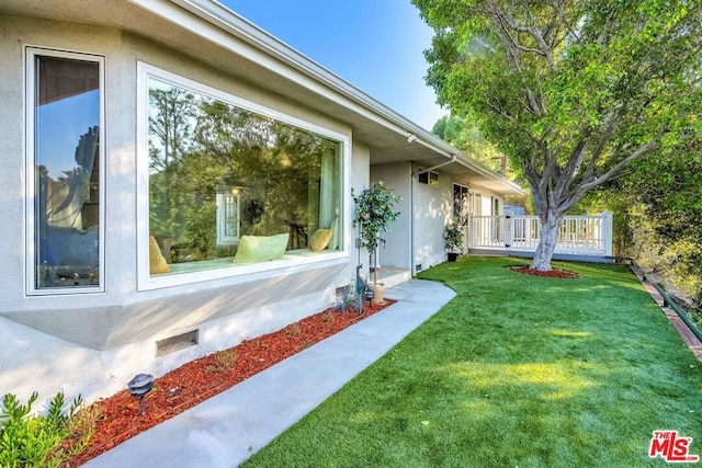 view of side of home featuring a lawn