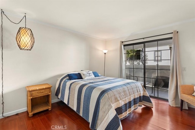 bedroom featuring crown molding and dark wood-type flooring