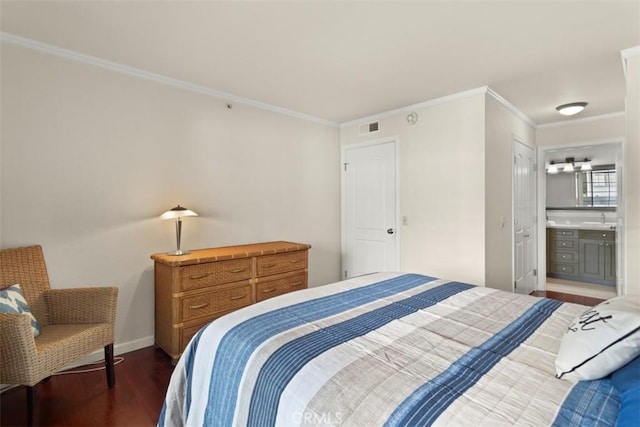 bedroom featuring ensuite bathroom, dark hardwood / wood-style flooring, crown molding, and sink