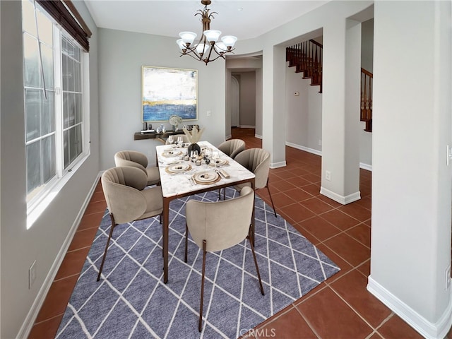 tiled dining area with a chandelier