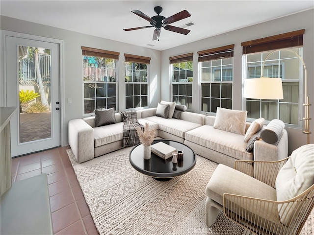 sunroom / solarium featuring ceiling fan