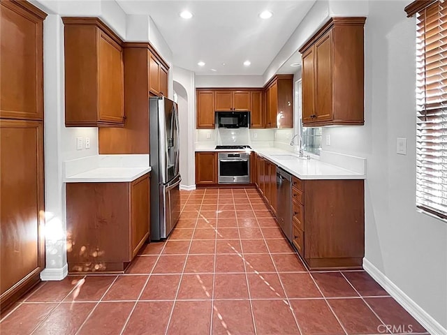 kitchen featuring appliances with stainless steel finishes, tile patterned floors, and sink