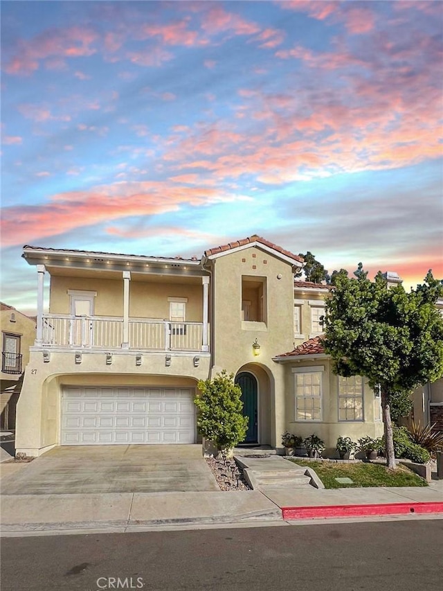 view of front of property with a balcony and a garage