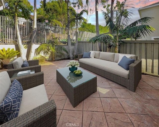 patio terrace at dusk featuring an outdoor hangout area