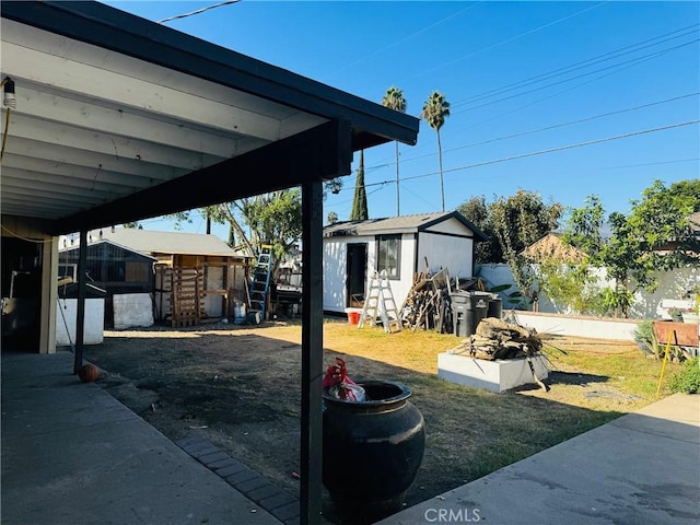 view of patio featuring a storage shed