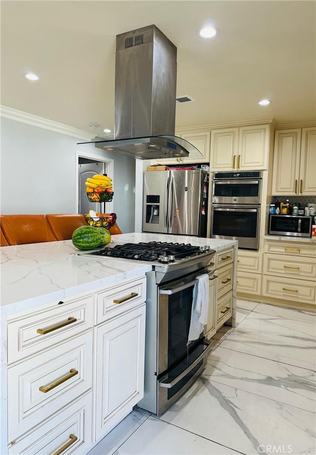 kitchen with cream cabinetry, stainless steel appliances, ornamental molding, and island range hood