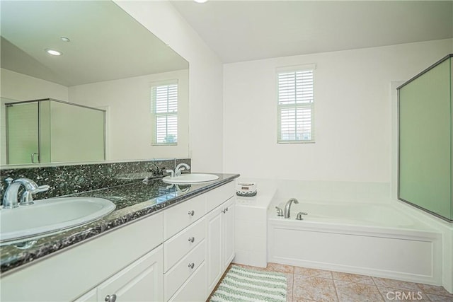 bathroom with tile patterned floors, plus walk in shower, vanity, and a healthy amount of sunlight