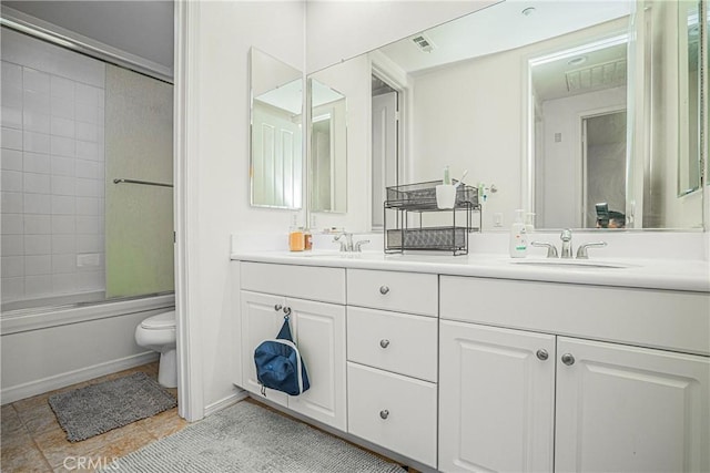 full bathroom with vanity, bath / shower combo with glass door, and toilet