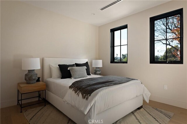 bedroom with hardwood / wood-style floors