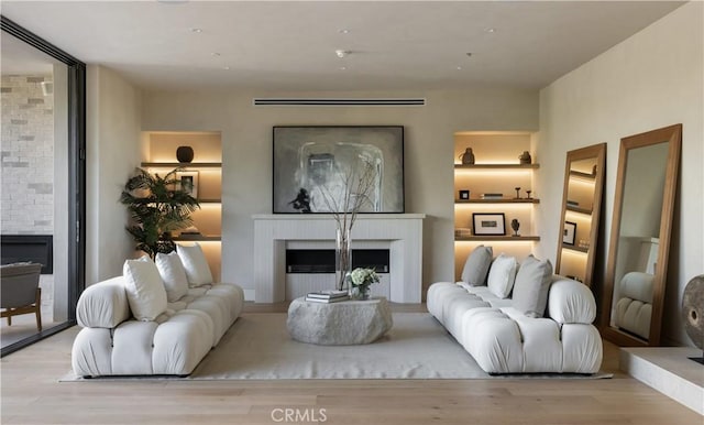 living room with a fireplace and light hardwood / wood-style flooring