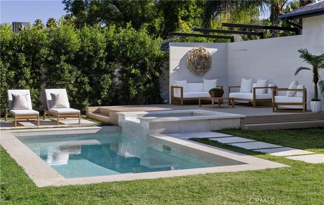 view of pool featuring a lawn, an outdoor living space, and an in ground hot tub