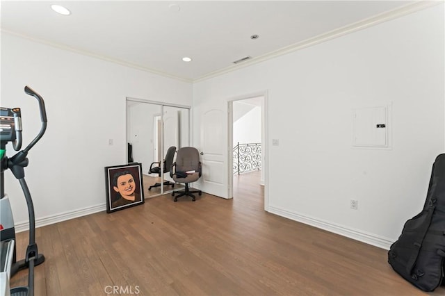 office with electric panel, crown molding, and wood-type flooring