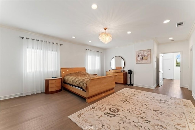 bedroom featuring crown molding, dark wood-type flooring, and a notable chandelier