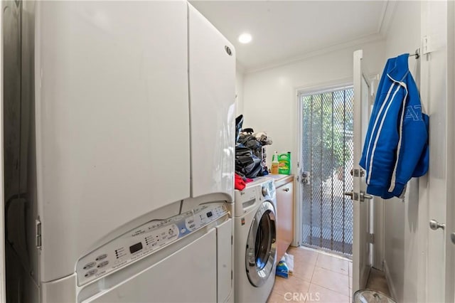 clothes washing area featuring independent washer and dryer, crown molding, and light tile patterned flooring