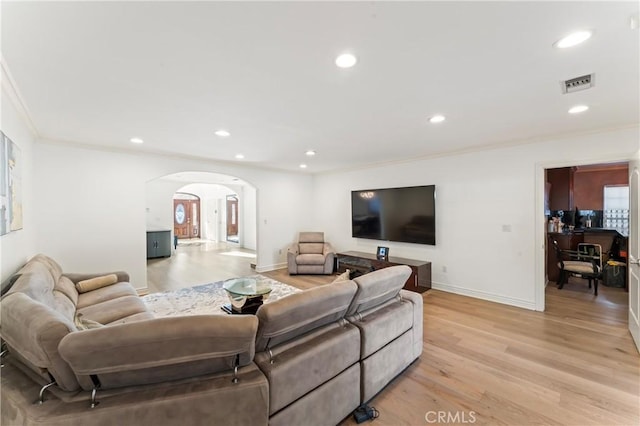 living room with light hardwood / wood-style floors and crown molding