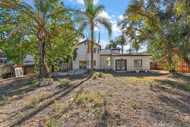 rear view of property featuring french doors