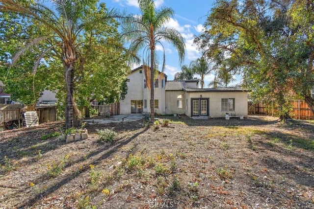 1520 W Norwood St, Rialto, CA 92377 - rear view of house with stucco siding, a patio, a fenced backyard, and french doors