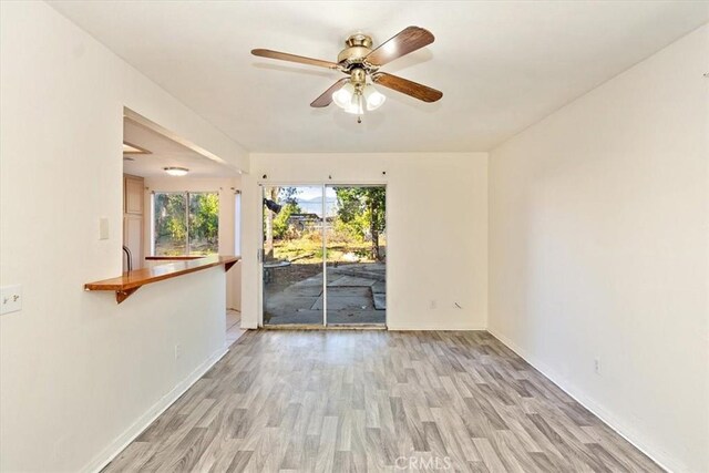 unfurnished room with light hardwood / wood-style flooring and ceiling fan