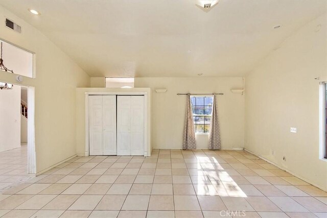 unfurnished bedroom with light tile patterned floors and a closet