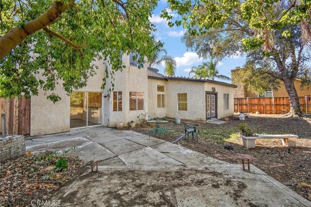 rear view of property featuring a patio area