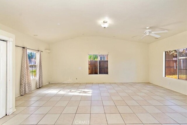 tiled empty room featuring ceiling fan and lofted ceiling