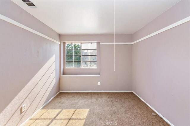 1520 W Norwood St, Rialto, CA 92377 - unfurnished room featuring baseboards, visible vents, and carpet flooring