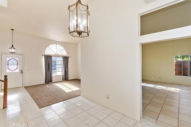 1520 W Norwood St, Rialto, CA 92377 - entrance foyer with light colored carpet, an inviting chandelier, a towering ceiling, and light tile patterned floors