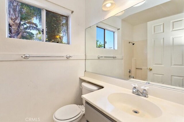 full bathroom featuring bathtub / shower combination, vanity, and toilet